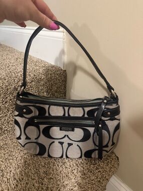 Coach Signature hobo bag is a black and gray jacquard shoulder bag